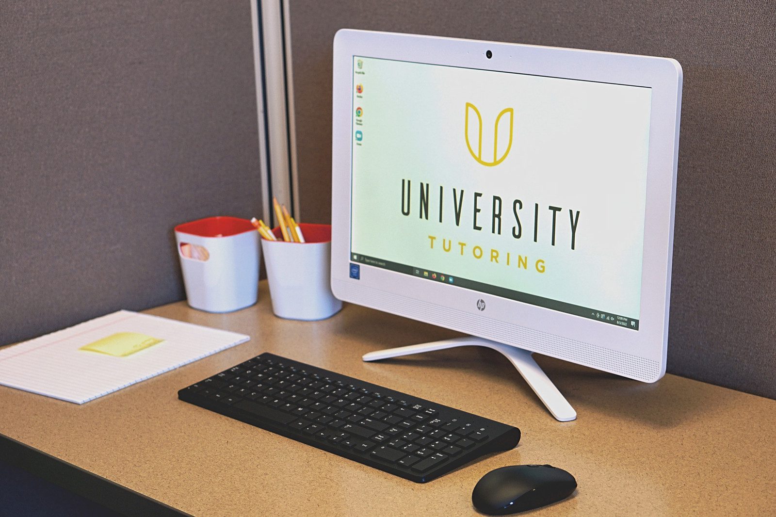 Photo of a computer with the University Tutoring logo